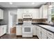 Bright kitchen with white cabinets, modern appliances, and dark countertops at 3505 Autumn Ct, Columbus, IN 47203