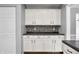 View of the kitchen area showing cabinetry, countertop and mosaic tile backsplash at 3505 Autumn Ct, Columbus, IN 47203