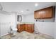 Spacious laundry room with cabinets, countertop space, sink, and plumbing for washer and dryer at 3505 Autumn Ct, Columbus, IN 47203