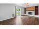 Spacious living room featuring sliding glass door and fireplace, hardwood floors at 3505 Autumn Ct, Columbus, IN 47203