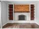 Bright living room with fireplace, custom shelving, and hardwood floors at 3505 Autumn Ct, Columbus, IN 47203