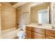 Cozy bathroom with tiled shower and wood vanity, featuring a modern sink, toilet, and hardware at 355 E Ohio St # 314, Indianapolis, IN 46204