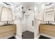 Bathroom with dual vanities, modern fixtures, and a glass-enclosed shower at 355 E Ohio St # 314, Indianapolis, IN 46204