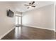 Spacious bedroom with hardwood floors, ceiling fan, and french doors to a balcony at 355 E Ohio St # 314, Indianapolis, IN 46204