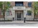 Inviting building entrance with stone facade, flags, and manicured landscaping enhances the curb appeal at 355 E Ohio St # 314, Indianapolis, IN 46204