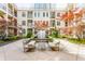 Picturesque courtyard featuring a central fountain, seating, and lush landscaping with mature trees at 355 E Ohio St # 314, Indianapolis, IN 46204