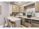 Stylish kitchenette featuring white marble counters, stainless appliances, and casual seating at 355 E Ohio St # 314, Indianapolis, IN 46204