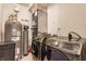 Well-equipped laundry area featuring modern washer and dryer units next to a water filtration system at 355 E Ohio St # 314, Indianapolis, IN 46204