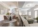 Spacious living room featuring an open-concept design, hardwood floors, a modern dining area, and a black-iron staircase at 355 E Ohio St # 314, Indianapolis, IN 46204