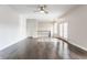 Spacious living room with hardwood floors, a ceiling fan, and french doors to a balcony at 355 E Ohio St # 314, Indianapolis, IN 46204