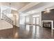 Bright open-concept living room featuring a fireplace, hardwood floors, staircase and ample natural light at 355 E Ohio St # 314, Indianapolis, IN 46204