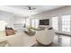 Bright living room featuring modern decor, a ceiling fan, hardwood floors, and access to a balcony with natural light at 355 E Ohio St # 314, Indianapolis, IN 46204