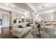 Open living space with hardwood floors, modern furniture, a dining area with decorative lighting, and a black-iron staircase at 355 E Ohio St # 314, Indianapolis, IN 46204