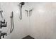 Walk-in shower stall features a black showerhead, white tiling and cubby shelving at 355 E Ohio St # 314, Indianapolis, IN 46204
