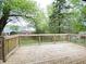 Spacious wooden back deck offering a serene outdoor living space with lush greenery at 3640 Breen Dr, Indianapolis, IN 46235
