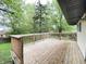 Spacious wooden back deck offering a serene outdoor living space with lush greenery at 3640 Breen Dr, Indianapolis, IN 46235