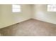 Bright bedroom with neutral walls and plush carpeting, illuminated by natural light from two windows at 3640 Breen Dr, Indianapolis, IN 46235