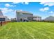 Large backyard with lush lawn and patio, providing ample space for recreation and outdoor living at 4032 Stubbington Ln, Indianapolis, IN 46239