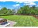 Spacious backyard with a well-maintained lawn and wooden fence, great for outdoor activities at 4032 Stubbington Ln, Indianapolis, IN 46239