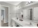 Bathroom featuring a double vanity, expansive mirrors, and modern lighting at 4032 Stubbington Ln, Indianapolis, IN 46239