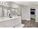 Bathroom with a double vanity, walk-in shower, and a walk-in closet at 4032 Stubbington Ln, Indianapolis, IN 46239