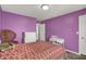 Bright bedroom with purple walls, white furniture, and cozy furnishings at 4032 Stubbington Ln, Indianapolis, IN 46239