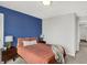 Comfortable bedroom with a blue accent wall and neutral carpeting at 4032 Stubbington Ln, Indianapolis, IN 46239
