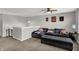 Comfortable bonus room featuring a large sectional sofa, ottoman, and ceiling fan at 4032 Stubbington Ln, Indianapolis, IN 46239