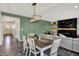 Dining area with elegant lighting and a view into the cozy living room at 4032 Stubbington Ln, Indianapolis, IN 46239