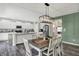 Dining area open to a kitchen with modern appliances and white cabinets at 4032 Stubbington Ln, Indianapolis, IN 46239
