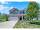 Charming two-story home with a well-manicured lawn and attached two-car garage at 4032 Stubbington Ln, Indianapolis, IN 46239