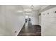 Long hallway featuring wood floors, a coat rack, and pendant lights at 4032 Stubbington Ln, Indianapolis, IN 46239