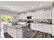 Bright kitchen with white cabinets, granite countertops, and stainless steel appliances at 4032 Stubbington Ln, Indianapolis, IN 46239