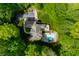 Aerial view of the beautiful home and pool nestled among lush greenery at 4128 Whitetail Woods Dr, Bargersville, IN 46106
