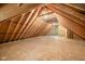 A spacious unfinished attic with exposed beams and natural light at 4128 Whitetail Woods Dr, Bargersville, IN 46106