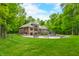 Secluded backyard featuring a pool, lush lawn and landscaping at 4128 Whitetail Woods Dr, Bargersville, IN 46106