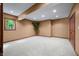 Finished basement offers a large carpeted area with a window and neutral paint at 4128 Whitetail Woods Dr, Bargersville, IN 46106