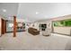 Basement living area with a bar, seating, and natural light from a window at 4128 Whitetail Woods Dr, Bargersville, IN 46106