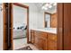 A charming bathroom with wood cabinets and a view into the bedroom at 4128 Whitetail Woods Dr, Bargersville, IN 46106