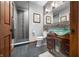 Bathroom featuring a walk-in shower, dark wood vanity and a unique glass bowl sink at 4128 Whitetail Woods Dr, Bargersville, IN 46106