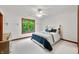 Neutral bedroom with a ceiling fan and bed near a bright window at 4128 Whitetail Woods Dr, Bargersville, IN 46106
