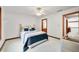 Bedroom with adjacent bathroom; ceiling fan; neutral walls; wood trim at 4128 Whitetail Woods Dr, Bargersville, IN 46106