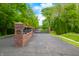 View of the gated entrance with brick pillars and sign at 4128 Whitetail Woods Dr, Bargersville, IN 46106