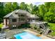 Beautiful home exterior featuring a spacious deck, and inviting pool, and lush greenery at 4128 Whitetail Woods Dr, Bargersville, IN 46106