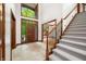Elegant foyer with tiled floors, staircase and views into other rooms and natural light at 4128 Whitetail Woods Dr, Bargersville, IN 46106