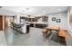 Open concept kitchen with dark wood cabinets, stainless appliances and adjacent breakfast table at 4128 Whitetail Woods Dr, Bargersville, IN 46106