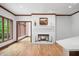 Bright living room boasts a white brick fireplace and large windows with outdoor views at 4128 Whitetail Woods Dr, Bargersville, IN 46106