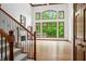 Bright living room with soaring ceilings, fireplace, and expansive windows overlooking the greenery at 4128 Whitetail Woods Dr, Bargersville, IN 46106