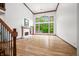 Bright living room featuring soaring ceilings, fireplace, and expansive windows overlooking the greenery at 4128 Whitetail Woods Dr, Bargersville, IN 46106
