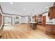 Open-concept living room features a cozy fireplace and a modern kitchen island at 4128 Whitetail Woods Dr, Bargersville, IN 46106